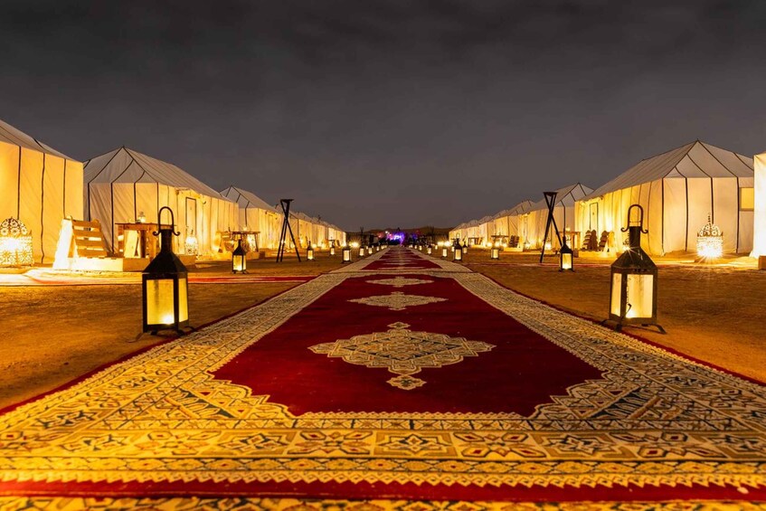 A row of tents with a carpeted walkway between them. 3