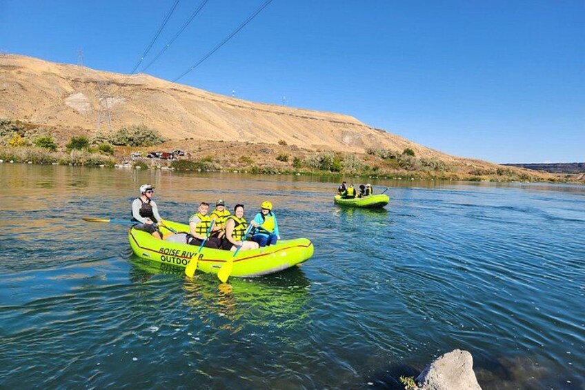 Two bright yellow boats on a calm river with a hilly landscape in the background. 5