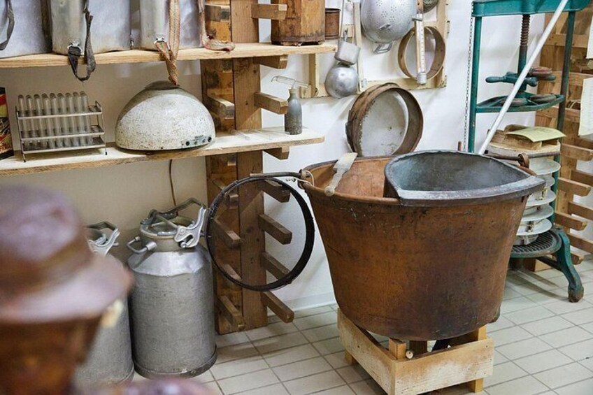 A rustic kitchen with various cooking utensils and pots. 5