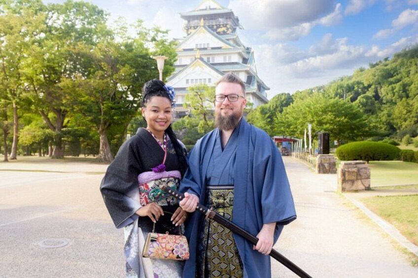 Een persoon in traditionele Japanse kleding voor een kasteel. 2