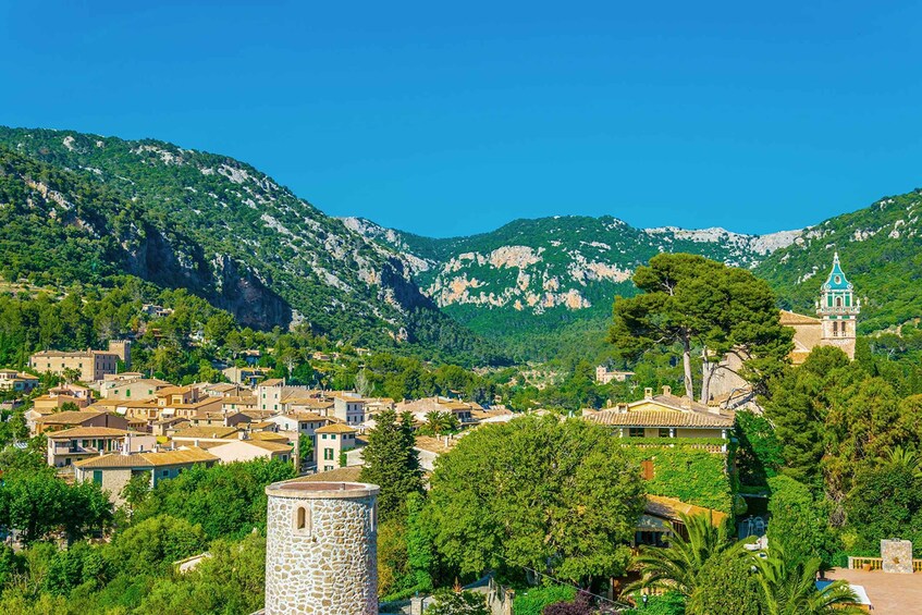 A mountainous town with historic buildings and a prominent church. 5