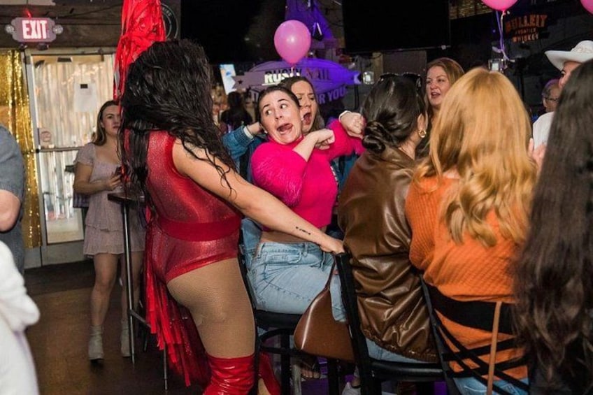 A group of people at a social event, some wearing party hats. 2