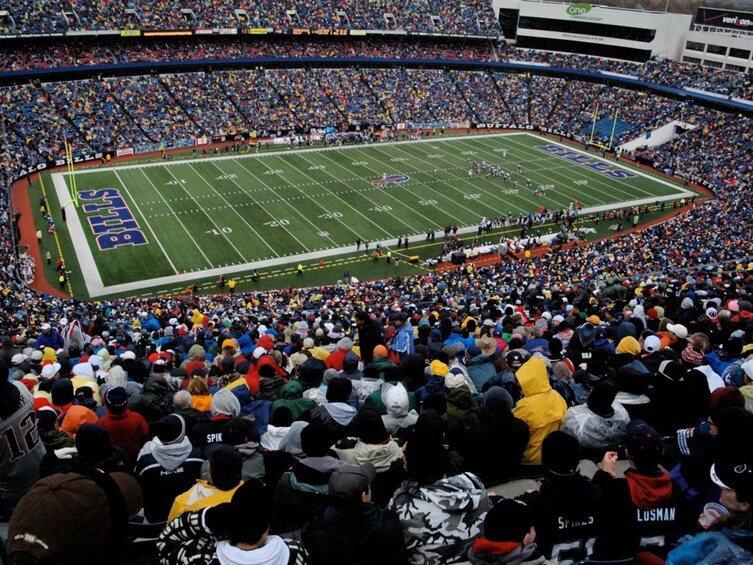 A football stadium filled with spectators. 4