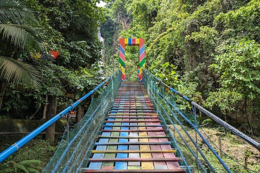 Access Mantayupan Waterfall via a vibrant, colorful bridge. 4
