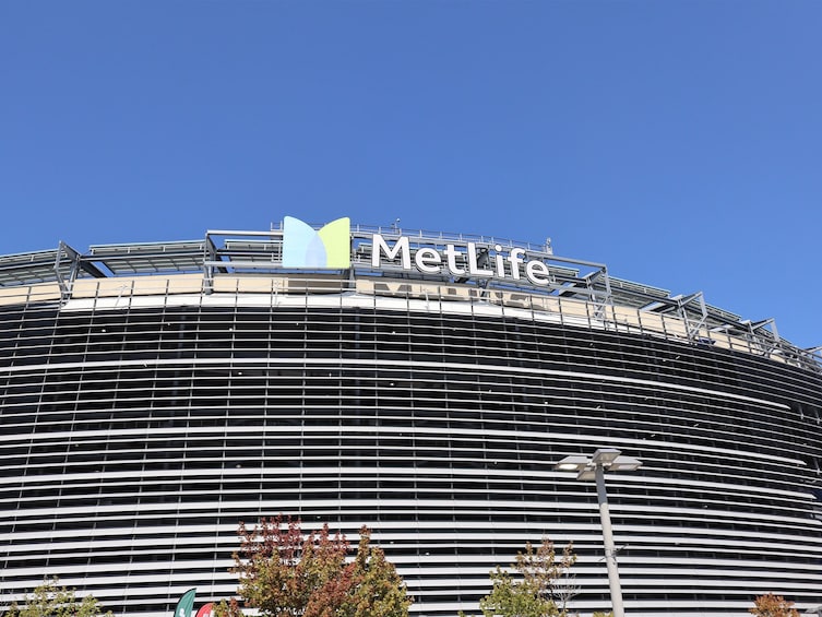 A MetLife building with a distinctive curved facade and a clear blue sky in the background. 3
