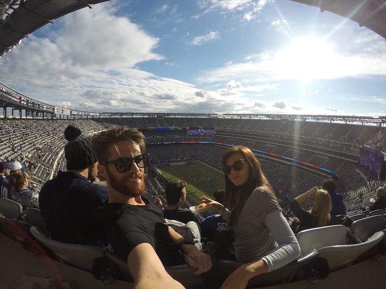 A stadium with a clear sky and a sun shining from behind the stands. 5