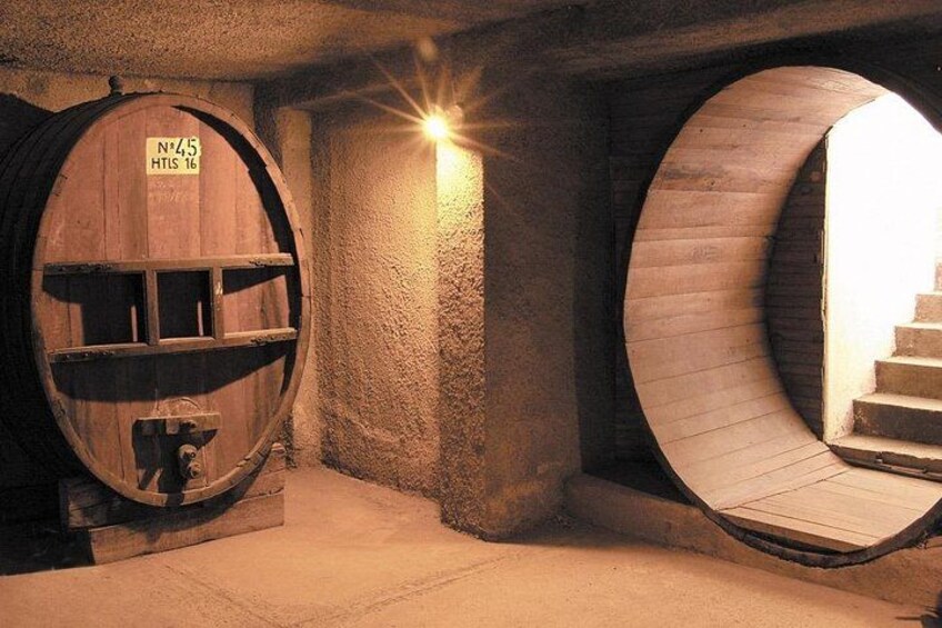 A circular stone structure with a wooden staircase inside. 3