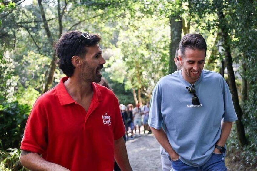 Two people walking in a wooded area. 2