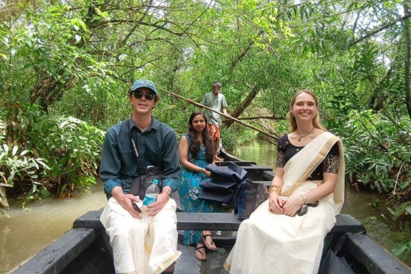 Three people on a boat in a forested area with dense vegetation. 3