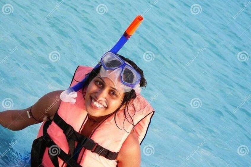 A person snorkeling with a snorkel and mask. 5