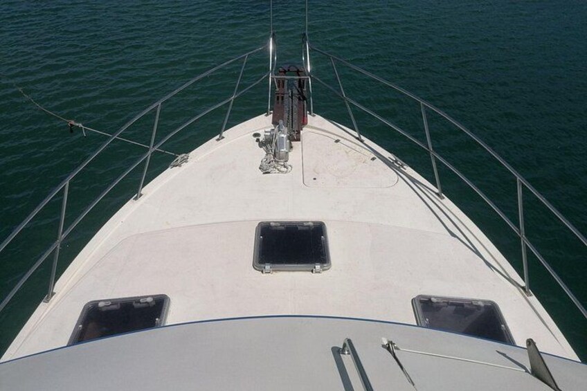 A boat's deck with two windows, a mast, and a railing. 3