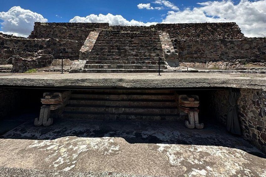 Ancient stone steps leading up to a pyramid-like structure. 4