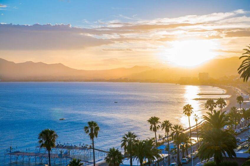 A coastal sunset with palm trees and a beach. 2