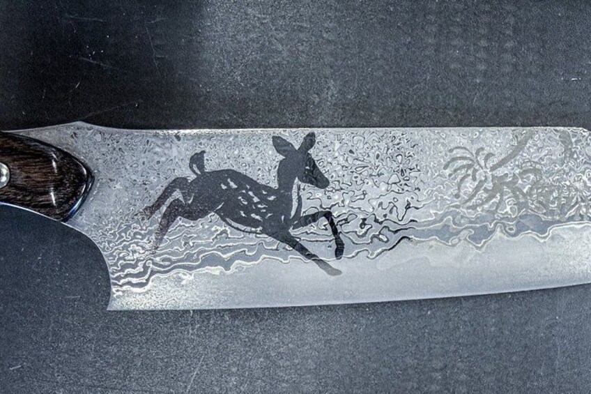 A knife with a kangaroo design etched into the blade. 4