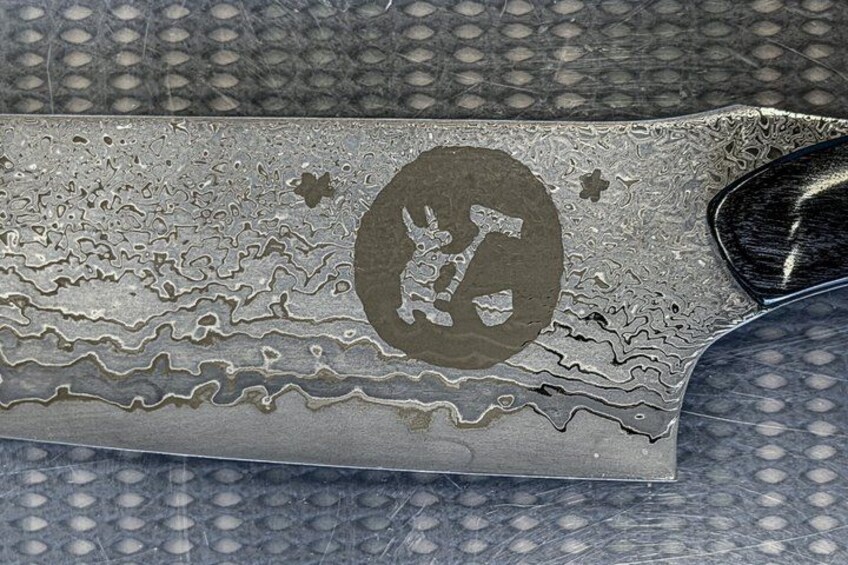 A knife with a detailed engraved design. 3
