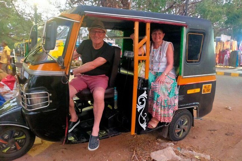 A man and a woman sitting in a tuk-tuk. 3