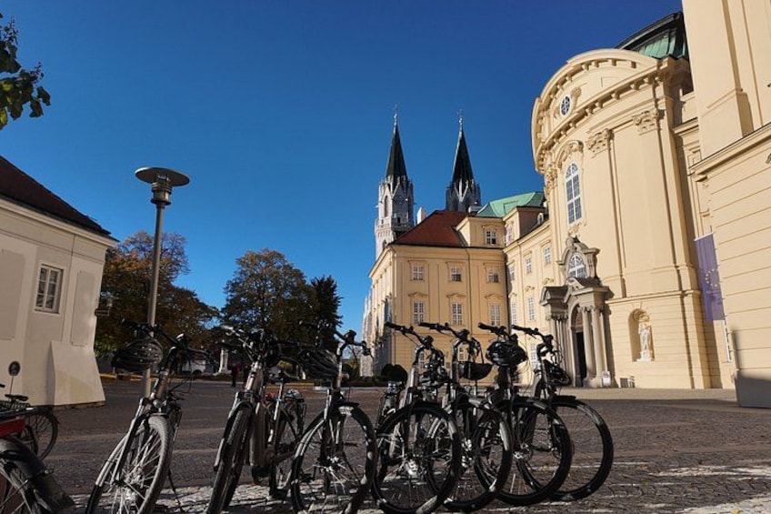 Bicycles parked in front of historic buildings with a clear sky. 3
