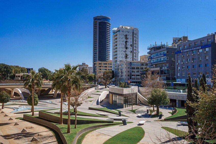 Un paisaje urbano con edificios modernos, un puente y una zona arbolada. 3