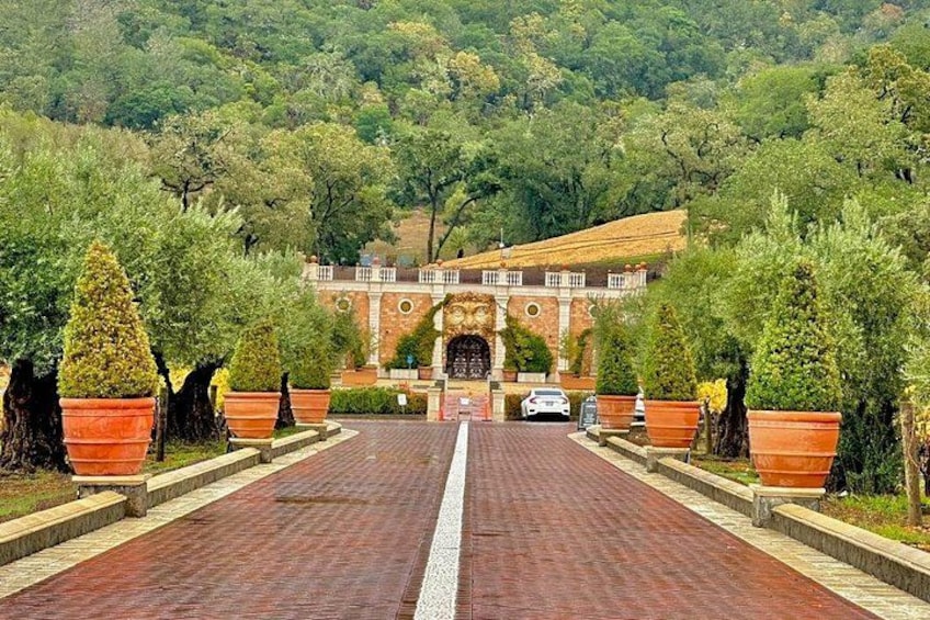 A paved pathway leading to a brick building with a circular window and a gate. 2