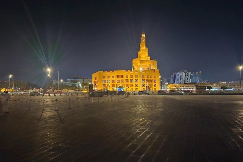 A large, illuminated building with a prominent tower at night. 3