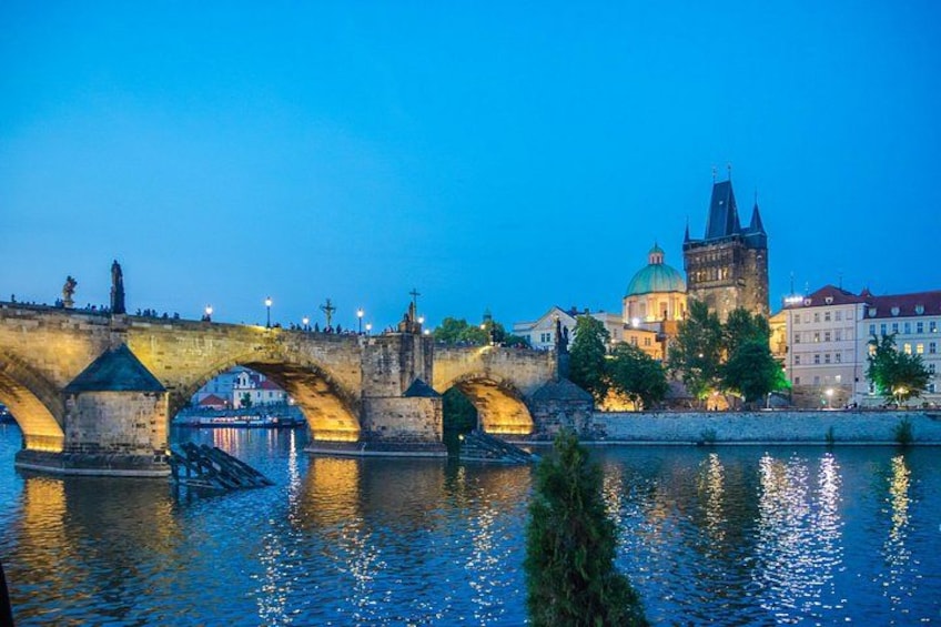 Un pont historique à arcades, une rivière et un bâtiment ressemblant à un château, surmonté d’un dôme vert. 2