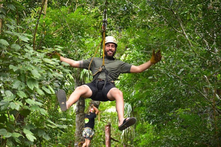 A person zip-lining through a forest. 5