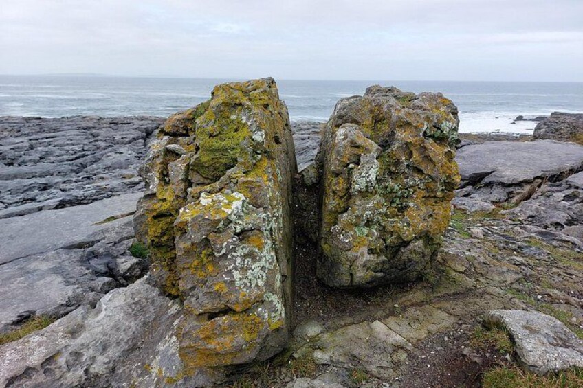 A rocky coastline with large boulders covered in lichen. 5