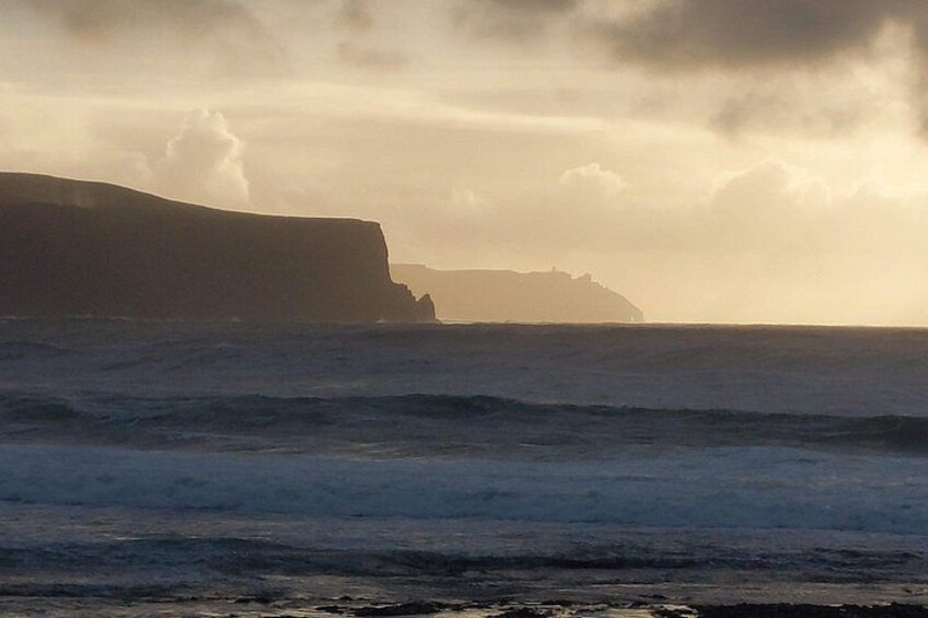 A coastal landscape with cliffs and the ocean. 2