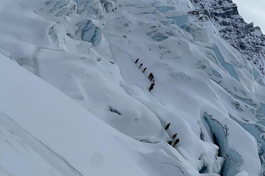 A glacier with crevasses and ice formations. 5