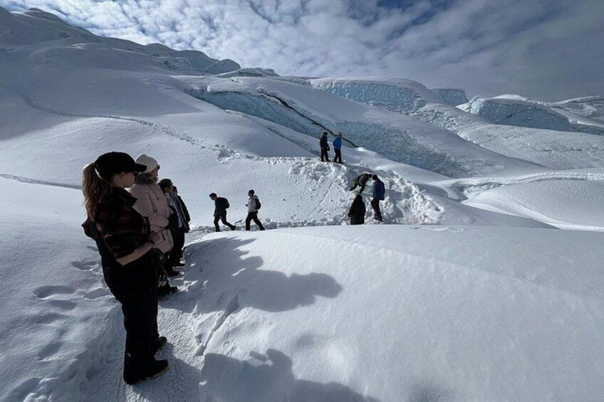 A group of people hiking on a snow-covered mountain. 5