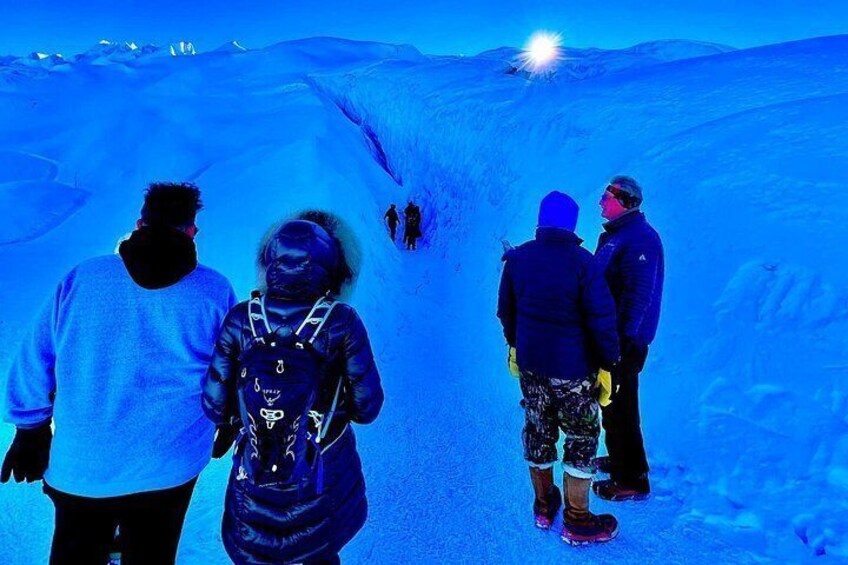 A group of people walking on a snow-covered path. 3