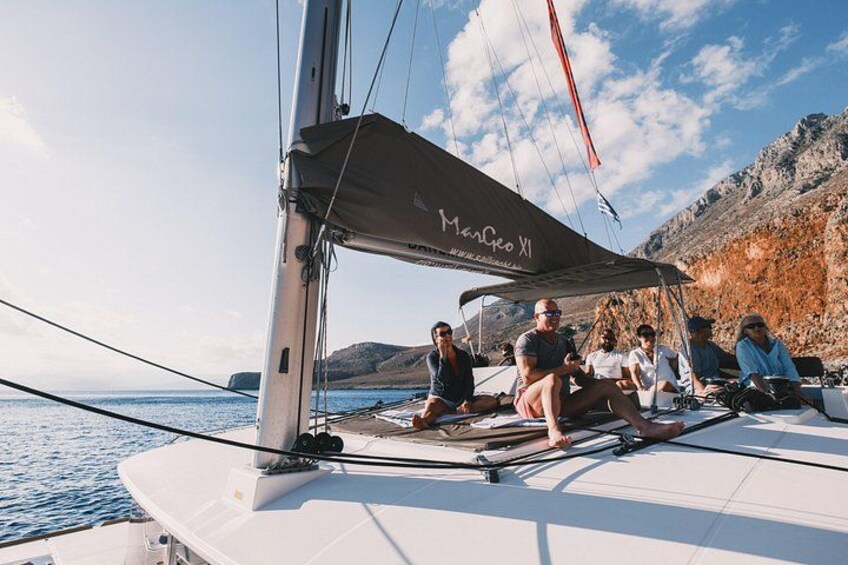 A sailboat named 'Marche XI' with people on deck. 5