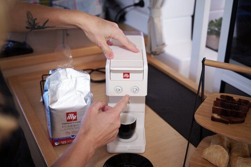 A person using a coffee machine to brew coffee. 4