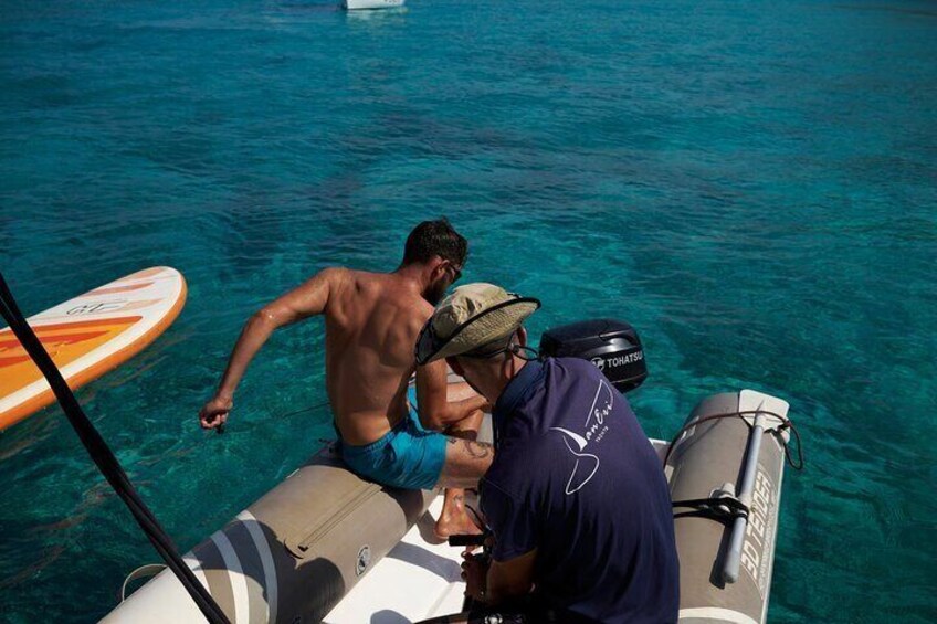 Two people on a boat in clear blue water. 2