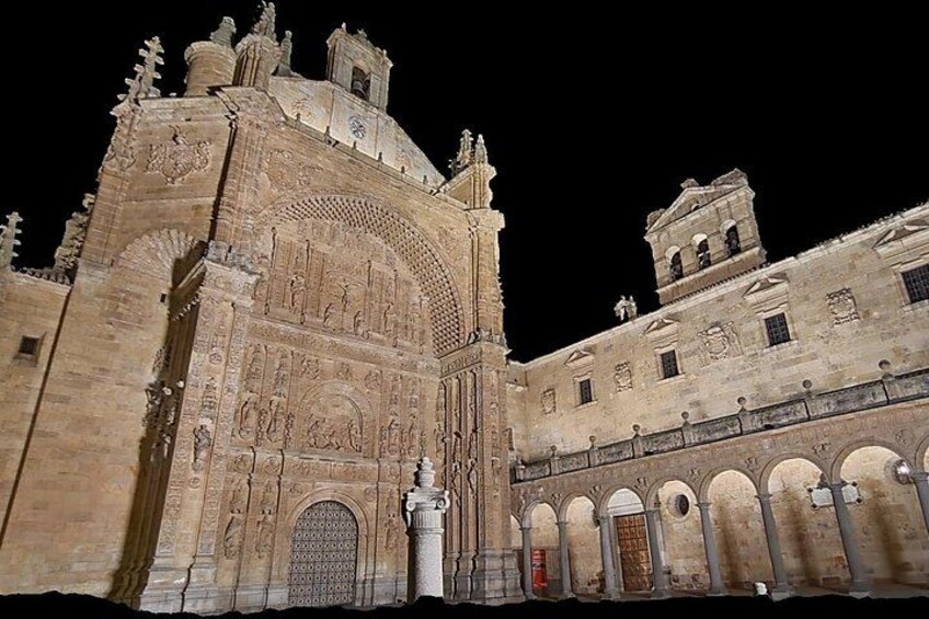 A historic building with detailed carvings and a large arched entrance. 3