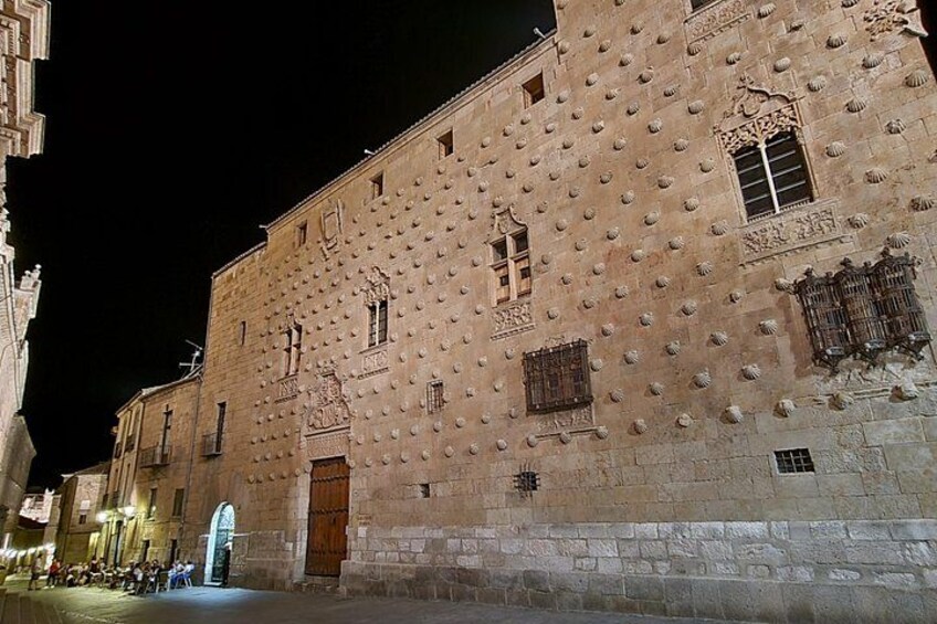 A historic building with a textured facade and arched windows. 2