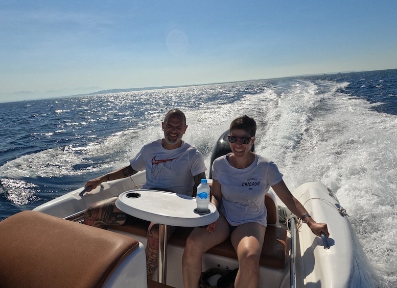 Two people on a boat with a table and a water bottle. 5