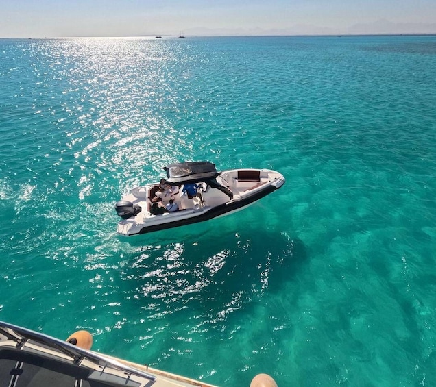 A boat on turquoise water with a clear sky. 3