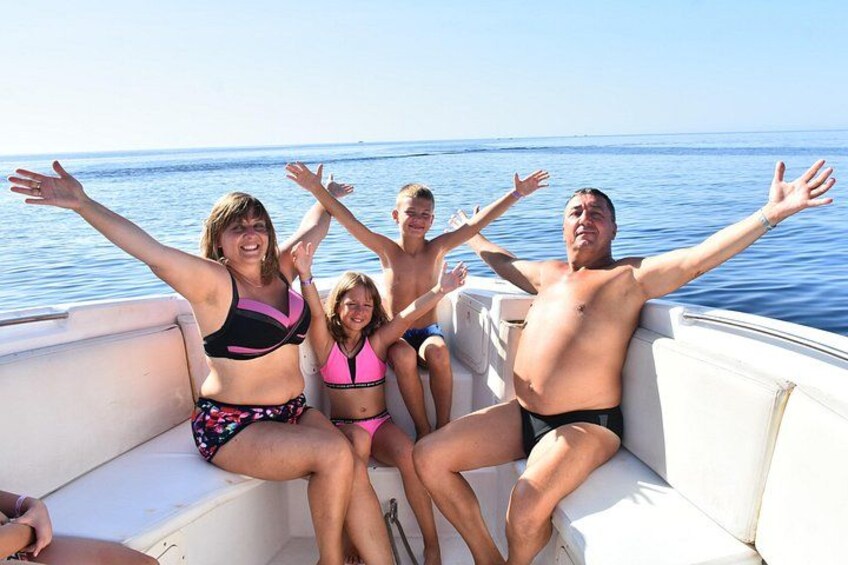A group of people on a boat with the sea in the background. 3