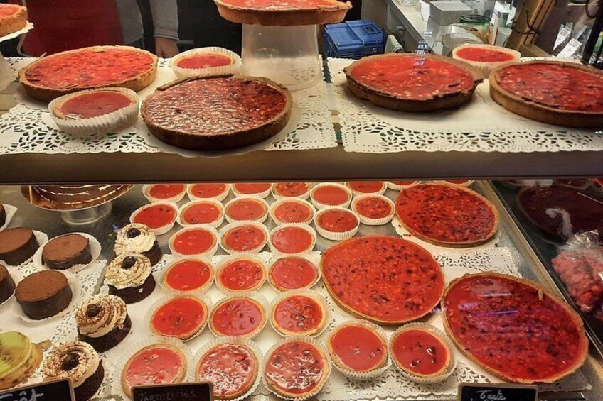 A display of various desserts, including cakes and pies, arranged on a table. 3