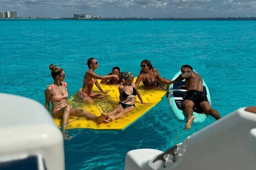 A group of people on a floating platform in the ocean. 2