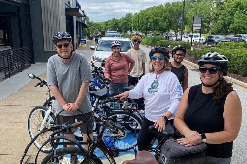 A group of people with bicycles in an urban setting. 3