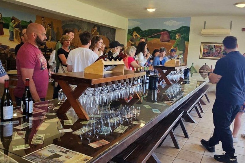 A bar with multiple wine bottles and glasses. 2