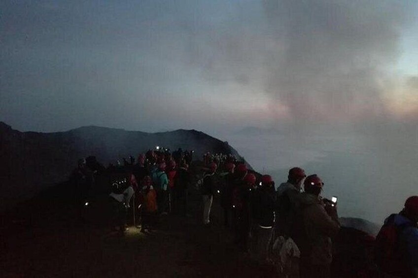 A group of people on a mountain at dusk. 2