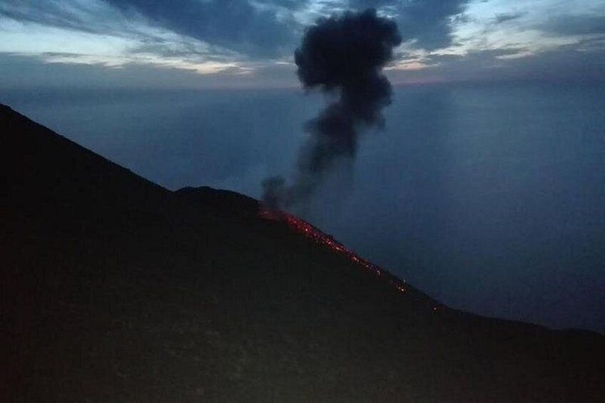 A mountain with a plume of smoke rising from its peak. 4