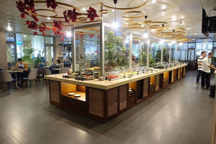 A modern cafe with a long counter, decorative hanging ornaments, and a view of the street outside. 5