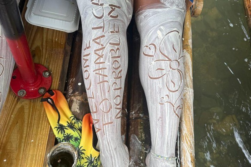 A boat with a wooden floor, a red pole, and a pair of white socks with embroidered designs. 3
