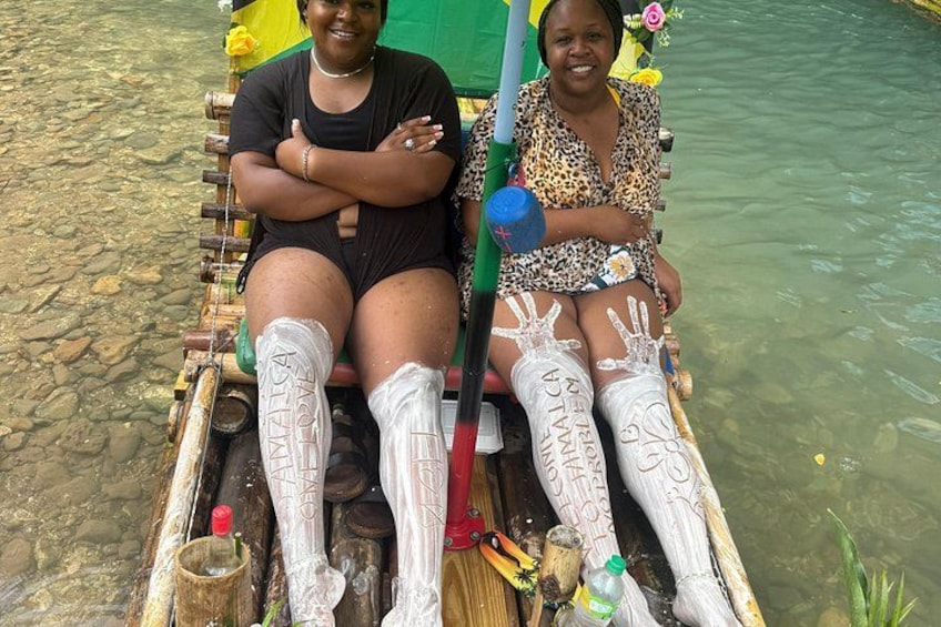 Two people sitting on a boat with decorative elements. 2