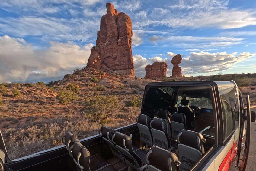 A vehicle with a backseat and a rocky landscape with prominent rock formations. 2