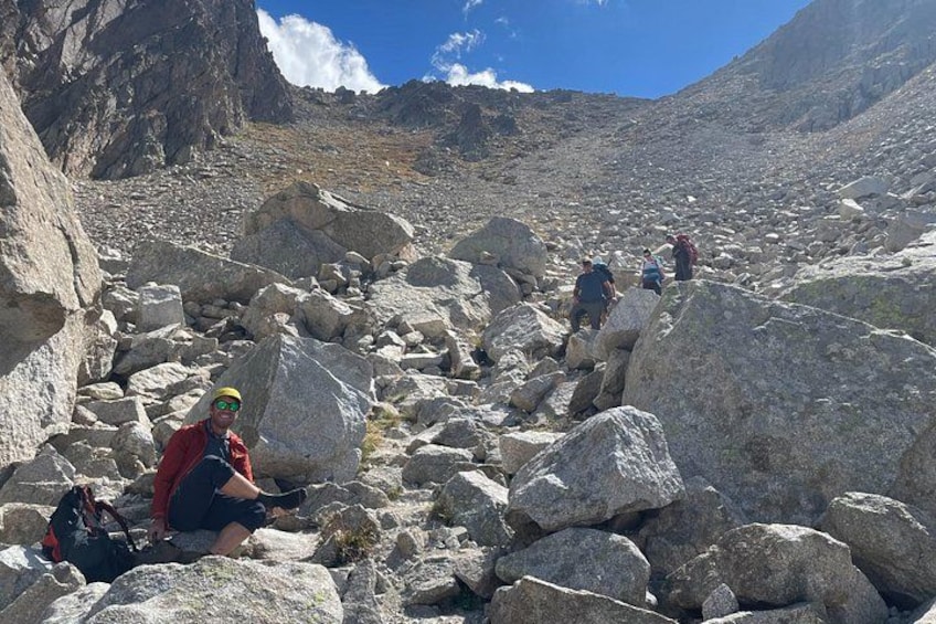 A rocky mountainous terrain with hikers. 2